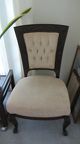low upholstered chair with carved wood